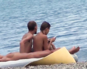 Nude beach girl is a slim beauty with a tattoo