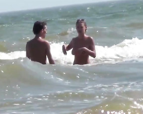 Nude beach girl caught on cam swimming in the sea with her boyfriend